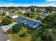 Aerial view of the home showcasing its well-manicured lawn, mature trees and landscaping at 10338 Se 178Th St, Summerfield, FL 34491