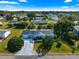 Aerial front of home showing the home's curb appeal, mature trees and landscaping at 10338 Se 178Th St, Summerfield, FL 34491