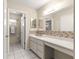 Bathroom featuring double sinks, vanity with a makeup counter, and mosaic-style tile at 10338 Se 178Th St, Summerfield, FL 34491