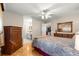 Comfortable bedroom showcasing a bed, dresser, hardwood floors and an ensuite bathroom at 10338 Se 178Th St, Summerfield, FL 34491