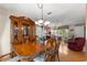 Dining area with wood table set, china cabinet, and view into the comfortable living room at 10338 Se 178Th St, Summerfield, FL 34491