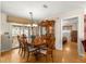 Open dining room featuring a wood table set and adjacent access to the screened lanai at 10338 Se 178Th St, Summerfield, FL 34491