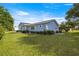 Exterior view of a well-maintained home, with manicured landscaping and healthy green lawn at 10338 Se 178Th St, Summerfield, FL 34491