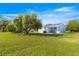 Exterior view of home with well-manicured lawn, low-maintenance landscaping and mature trees at 10338 Se 178Th St, Summerfield, FL 34491