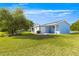 Exterior view of home featuring a well manicured lawn and low-maintenance landscaping at 10338 Se 178Th St, Summerfield, FL 34491