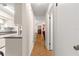 Hallway with parquet flooring leading to kitchen and living spaces at 10338 Se 178Th St, Summerfield, FL 34491