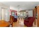 Bright living room featuring hardwood floors, a ceiling fan, and large window at 10338 Se 178Th St, Summerfield, FL 34491