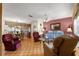 Comfortable living room featuring hardwood floors, a ceiling fan and natural light at 10338 Se 178Th St, Summerfield, FL 34491