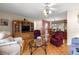 Inviting living room with hardwood floors, a ceiling fan and an adjacent dining area at 10338 Se 178Th St, Summerfield, FL 34491