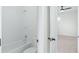 Bathroom features a shower-tub combination and doorway leading into bedroom at 1041 Linehart Dr, Winter Garden, FL 34787