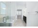 Bathroom showcasing a glass-enclosed shower, soaking tub, and dual vanity at 1041 Linehart Dr, Winter Garden, FL 34787