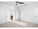 Spacious bedroom with carpet flooring, a fan, and adjacent bathroom at 1041 Linehart Dr, Winter Garden, FL 34787