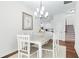 Bright dining room featuring white table and chairs, with view to the kitchen and staircase at 1041 Linehart Dr, Winter Garden, FL 34787