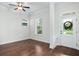 Hardwood floors fill the room, brightened by natural light from the windows, and a ceiling fan overhead at 1041 Linehart Dr, Winter Garden, FL 34787