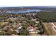 Aerial view of the property location in a serene neighborhood by a lake at 10413 Lake Hill Dr, Clermont, FL 34711