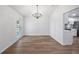 Empty dining room space with hardwood floors, a chandelier, and modern design at 10413 Lake Hill Dr, Clermont, FL 34711