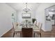 Dining room with hardwood floors, chandelier, and decorative place settings at 10413 Lake Hill Dr, Clermont, FL 34711