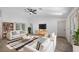 Bright living room featuring a vaulted ceiling, skylight and modern furniture at 10413 Lake Hill Dr, Clermont, FL 34711