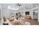 Bright, modern living room with skylights, wood floors, and stylish furnishings at 10413 Lake Hill Dr, Clermont, FL 34711