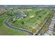 Expansive aerial view of a golf course, clubhouse, and a residential neighborhood at 1067 Mesa Verde Court, Clermont, FL 34711