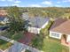 Aerial shot of a well-maintained home featuring a red brick driveway and beautiful landscaping at 1067 Mesa Verde Court, Clermont, FL 34711