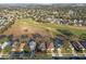 Expansive aerial view showcases the home's proximity to the golf course at 1067 Mesa Verde Court, Clermont, FL 34711