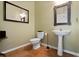 Traditional half-bath with pedestal sink, framed mirrors, and tile flooring at 1067 Mesa Verde Court, Clermont, FL 34711