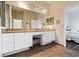 Bathroom with double granite-top sinks, vanity, and tile flooring at 1067 Mesa Verde Court, Clermont, FL 34711