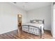 Cozy bedroom with wood-look floors and an en-suite bathroom at 1067 Mesa Verde Court, Clermont, FL 34711