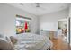 Bright bedroom with hardwood floors, ceiling fan and view to an outdoor patio at 1067 Mesa Verde Court, Clermont, FL 34711