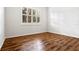 Empty bedroom with hardwood floors and bright window with shutters at 1067 Mesa Verde Court, Clermont, FL 34711