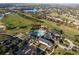 Aerial view shows the fantastic community center with a large pool, clubhouse, and lush landscaping at 1067 Mesa Verde Court, Clermont, FL 34711