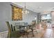 Elegant dining room with a glass table, stylish chandelier, and neutral decor at 1067 Mesa Verde Court, Clermont, FL 34711