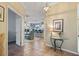 Inviting foyer with a glass table and a view into the dining and kitchen area at 1067 Mesa Verde Court, Clermont, FL 34711