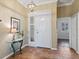 Bright foyer with tile flooring, elegant lighting, and a glimpse into the living area at 1067 Mesa Verde Court, Clermont, FL 34711