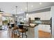 Modern kitchen featuring a breakfast bar, stainless steel appliances, and white cabinets at 1067 Mesa Verde Court, Clermont, FL 34711