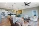 Open concept living room with kitchen island, dining area, and sliding doors to the outside at 1067 Mesa Verde Court, Clermont, FL 34711