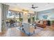 Bright living room with sliding glass doors leading to outdoor seating area overlooking the yard at 1067 Mesa Verde Court, Clermont, FL 34711