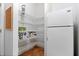 Walk-in pantry equipped with metal shelves, a refrigerator, and a cork board at 1067 Mesa Verde Court, Clermont, FL 34711