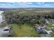 Aerial view showcasing the lush landscaping and boat shed, complemented by an expansive lawn at 1102 N Palmetto St, Leesburg, FL 34748