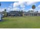 Aerial view of the backyard, outbuilding and neighboring screened-in pools at 1102 N Palmetto St, Leesburg, FL 34748