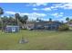 An aerial view of the outbuilding and pool area overlooking the expansive lawn at 1102 N Palmetto St, Leesburg, FL 34748