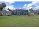 Expansive lawn featuring the enclosed pool area and convenient outbuilding at 1102 N Palmetto St, Leesburg, FL 34748