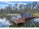 Boat dock equipped with a boat lift and shed, offering convenient waterfront access and storage at 1102 N Palmetto St, Leesburg, FL 34748