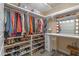 Walk-in closet with ample storage and a vanity area with a lighted mirror at 1102 N Palmetto St, Leesburg, FL 34748