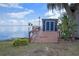 Waterfront dock featuring a seating area and shed, perfect for lakeside relaxation and boat storage at 1102 N Palmetto St, Leesburg, FL 34748