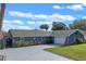 Beautiful single-story home boasts a spacious driveway and well-manicured lawn at 1102 N Palmetto St, Leesburg, FL 34748