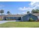 This charming single-story home has lush landscaping and a wide driveway at 1102 N Palmetto St, Leesburg, FL 34748