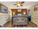 Comfortable main bedroom featuring wood accent wall, ceiling fan, and neutral decor at 1102 N Palmetto St, Leesburg, FL 34748