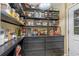 Well-organized pantry with black shelving, drawers, and a variety of storage solutions for food and kitchen essentials at 1102 N Palmetto St, Leesburg, FL 34748